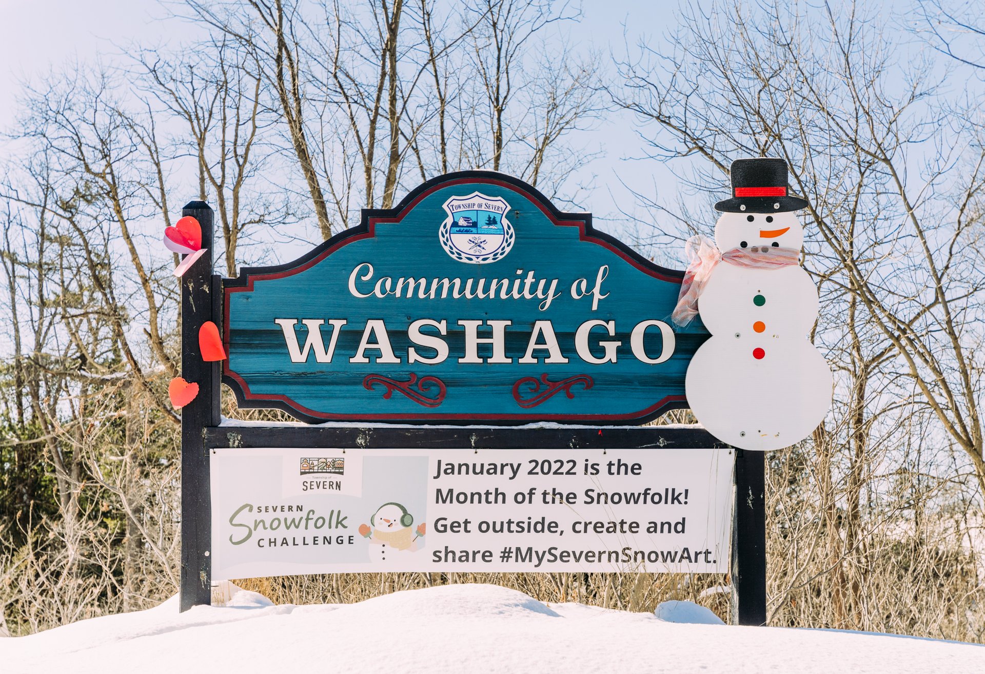 Community of Washago sign with snowman in the winter