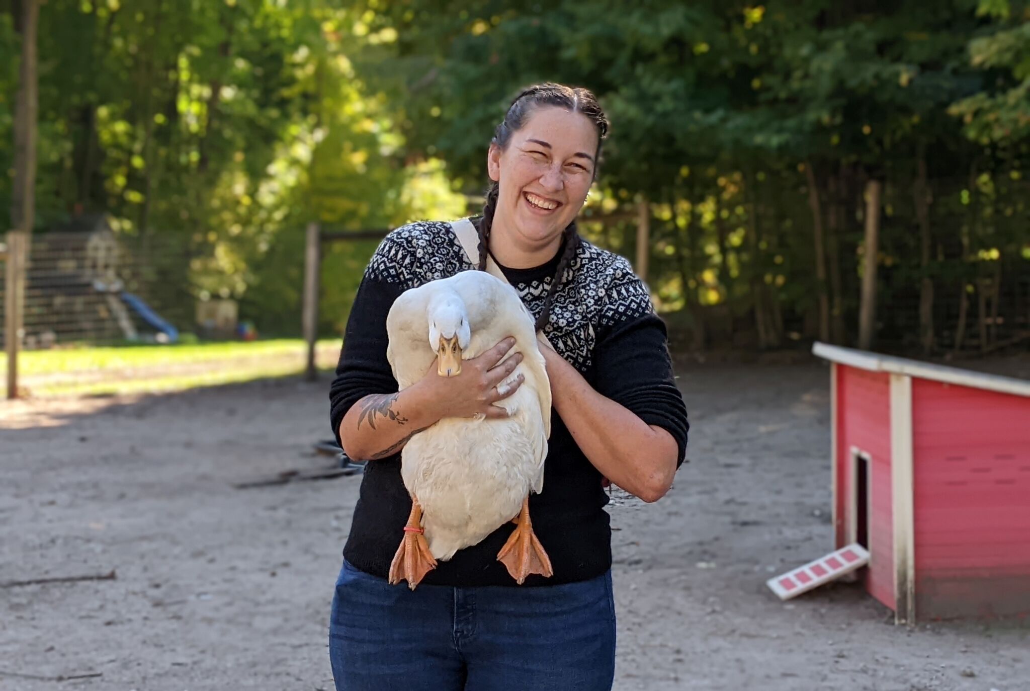 Woman holding duck during farm tour experience