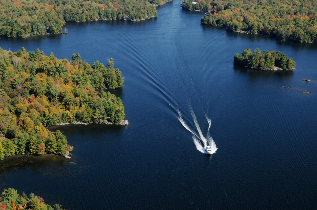 aerial shot of boat on the clear blue waters of the Trent Severn Waterway 