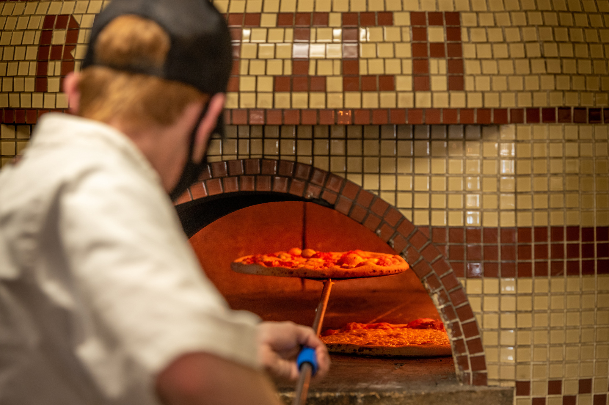 Chef making wood-fired pizza